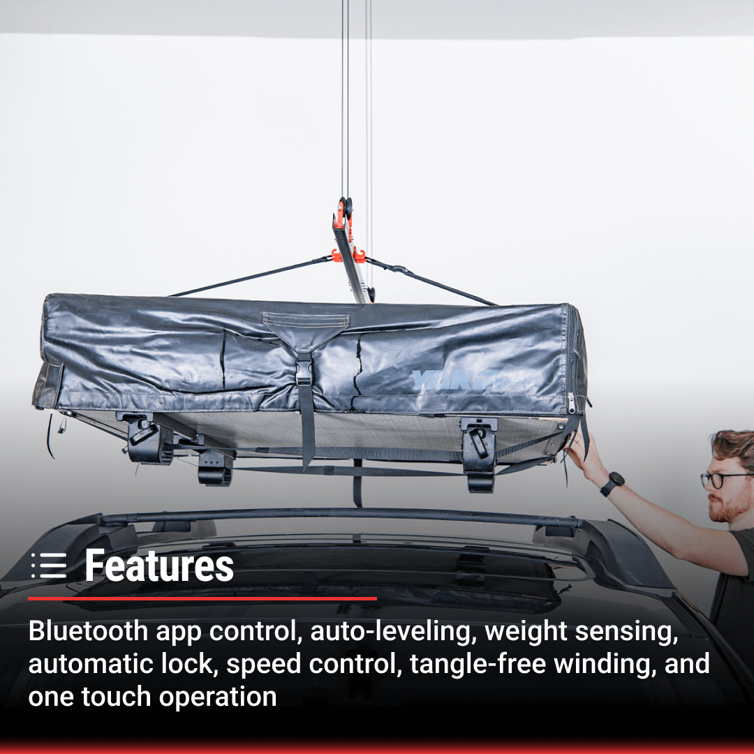 Man using motorized garage storage lift with Bluetooth app control to lift rooftop tent.