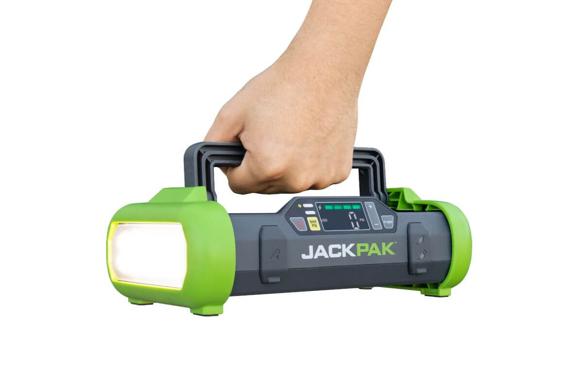 JackPak ULTRA2500A multifunction jump starter and air compressor in hand, featuring an LED flashlight and user interface.