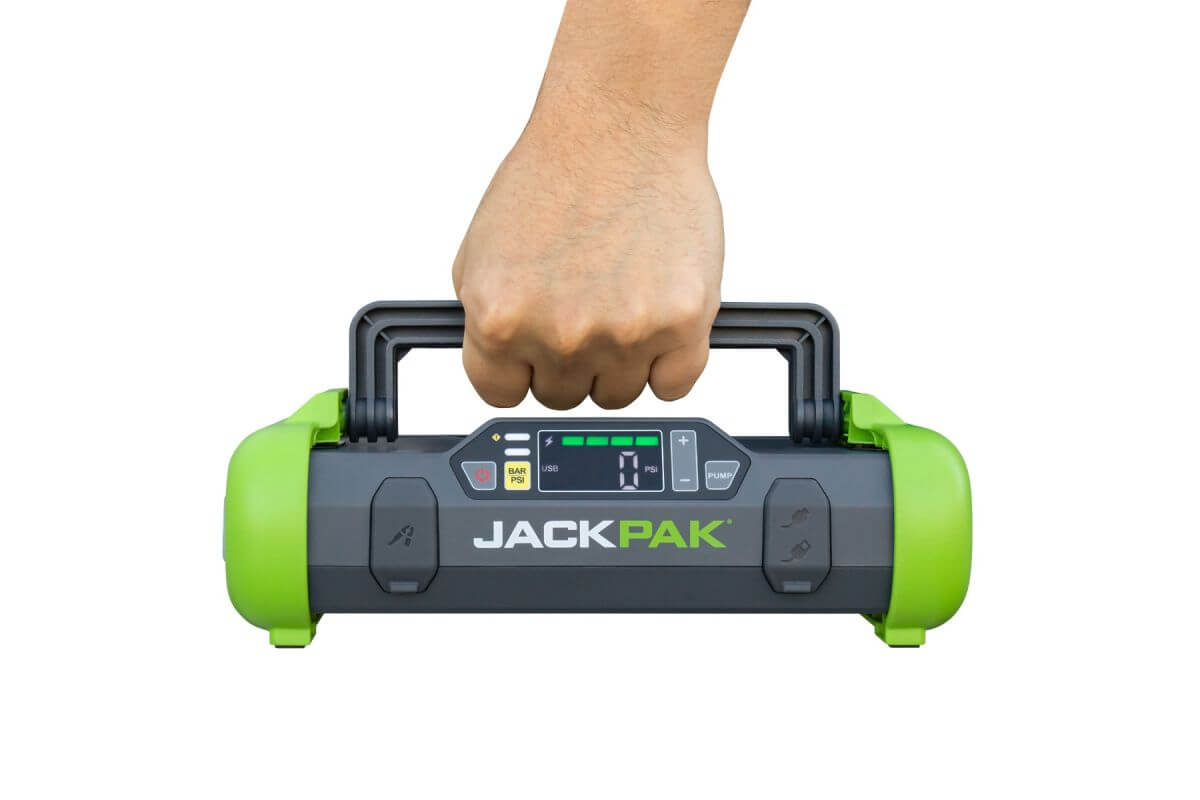 JackPak ULTRA2500A jump starter and air compressor being held, showcasing its compact and portable design.