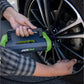 Person using JackPak ULTRA2500A jump starter and air compressor on a car tire.