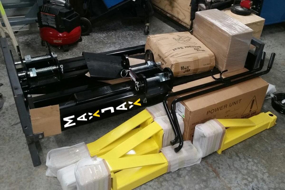 MaxJax M7K 2 Post Car Lift components, showcasing the portable lift and power unit in packaging.