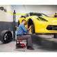 MaxJax M7K 2 Post Car Lift in action with a mechanic working on a yellow sports car's wheel.