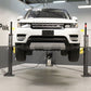 MaxJax M7K 2 post car lift in a professional garage lifting a white SUV.