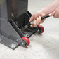 Close-up of a person using a wrench on the base of a MaxJax M7K two post car lift with red wheels.