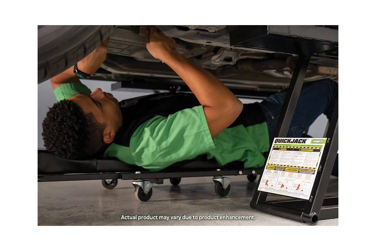 User working under a car using QuickJack portable car lift for efficient vehicle repairs.