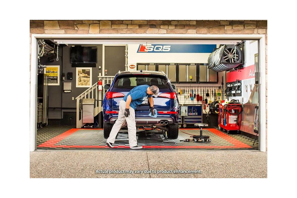 Mechanic using QuickJack 5000TL portable car lift in garage for vehicle repairs.