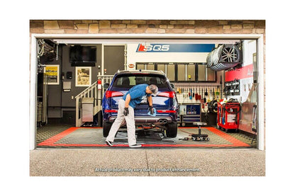 Mechanic using QuickJack 5000TL portable car lift in garage for vehicle repairs.