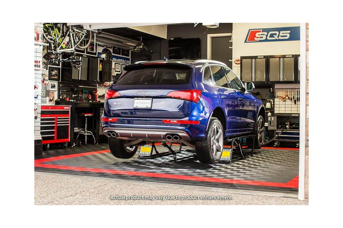 Blue SUV elevated on QuickJack 5000TL portable car lift in a professional garage setting.