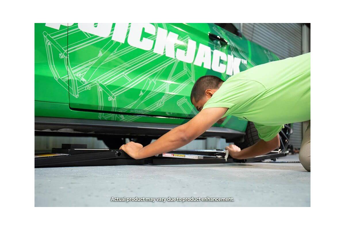 User operating the QuickJack 5000TL portable car lift, showcasing its ease of use and innovative design.