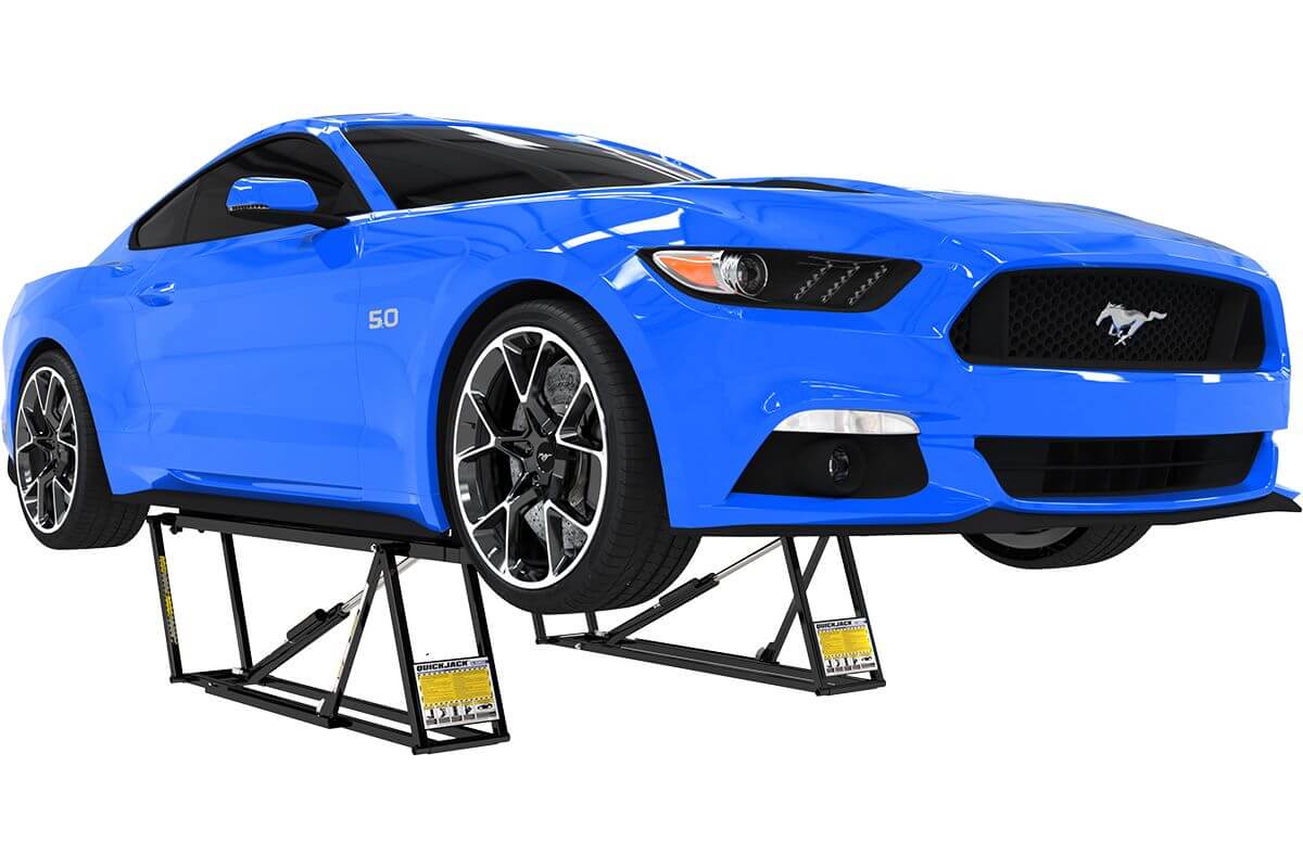 Blue Ford Mustang elevated on QuickJack 5000TLX portable car lift showcasing its 5000 lb capacity. 