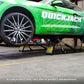 QuickJack 7000TL portable car lift raising a green Mustang in an auto shop, showcasing its 7000 lb capacity.