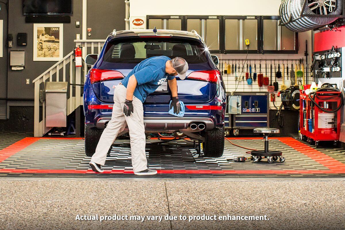 Mechanic using QuickJack 7000TL portable car lift in a garage, showcasing 7000 lb capacity for trucks and SUVs.