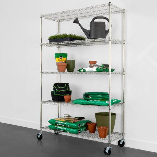 SafeRacks 5-tier wire rack with gardening supplies, pots, and a watering can for organized storage solutions.