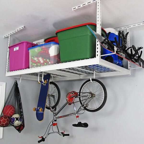 Overhead garage storage rack holding colorful bins, sports equipment, and a bike, optimizing space in a garage.