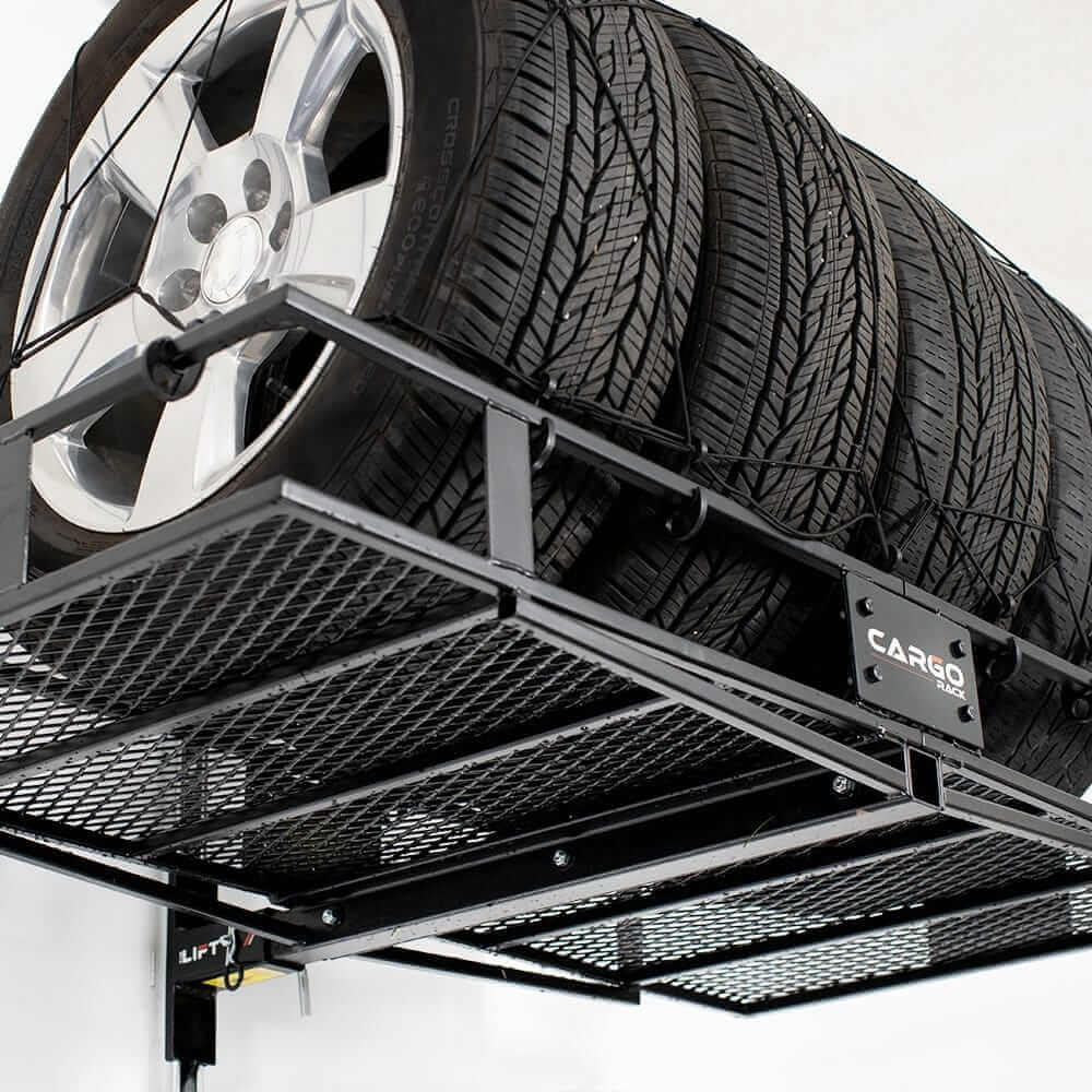 Motorized overhead storage lift with tires securely stored on a metal rack for easy access and organization.