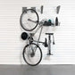 storeWALL Basic Bike Bundle showing a bike and accessories stored on the wall efficiently with hooks and a basket.