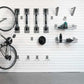 Organized bike storage with Steadyrack brackets, hooks, and baskets for easy access and space-saving.