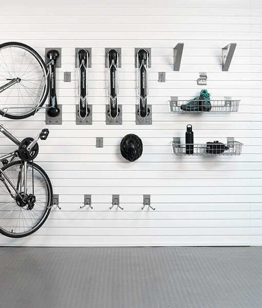 Organized bike storage with Steadyrack brackets, hooks, and baskets for easy access and space-saving.