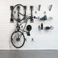 storeWALL Deluxe Bike Bundle showcasing organized bike storage with hooks and baskets on a slatwall.