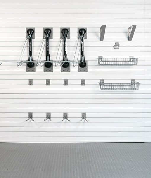Wall-mounted bike storage solution featuring Steadyrack brackets and hooks for efficient organization. 